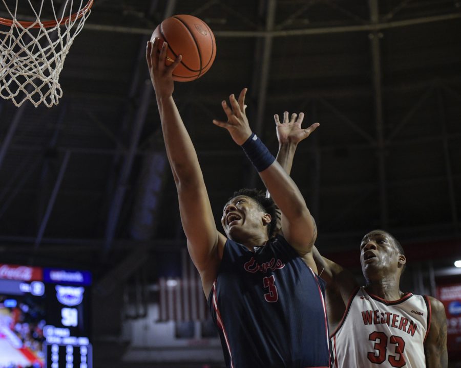 Florida Atlantic Owls freshman forward Giancarlo Rosado (3) leaps for a shot as of Western Kentucky University Hilltoppers junior center Jamarion Sharp (33) attempts a stuff from behind Thursday evening, Feb. 10, 2022, in Diddle Arena. WKU won the match 76-69.