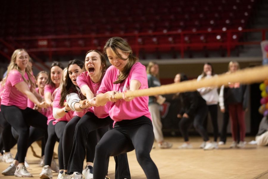 Members of Alpha Gamma Delta struggle to win in a Tug of War event against Phi Mu at Midnight on the Hill on Friday, March 25th.
