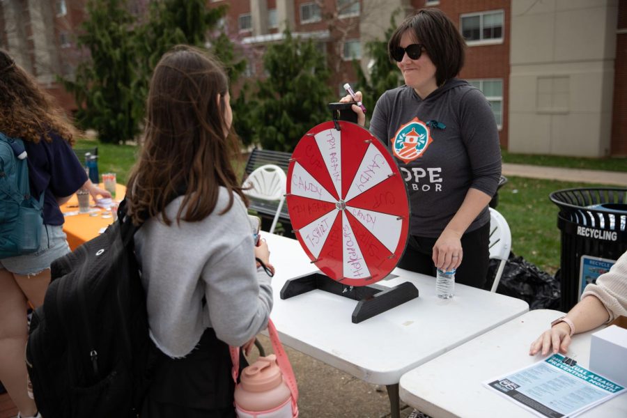 Maja O’Connell of Hope Harbor helps to table on campus on Wednesday, March 30th for sexual assault awareness on campus. Students received free prizes, such as t-shirts, cups, pens, etc. when they spun the wheel. 