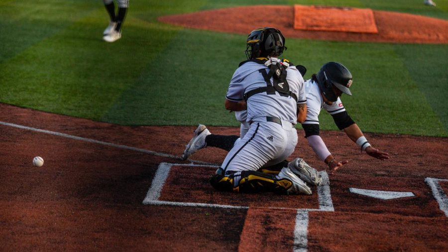 Hilltopper Baseball’s infielder Tristin Garcia (7) dives for home to put a run on the board against the Golden Eagles during their matchup with The University of Southern Mississippi on March 25th at Nick Denes Field.