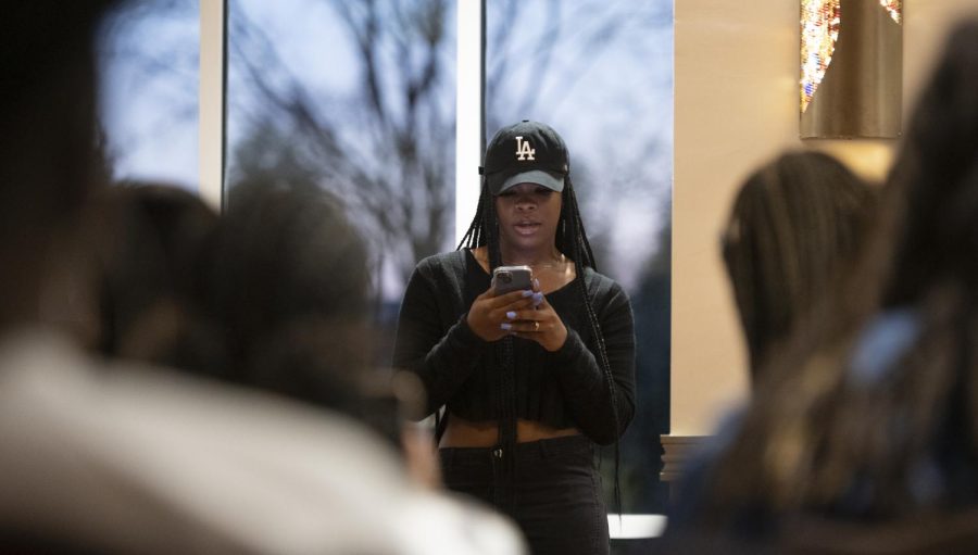 Western Kentucky University senior fashion merchandising and interior design student Briah Floyd, 22, recites a poem Thursday evening, March 24, 2022 in the ballroom of Mahurin Honors College where Blaq Art Nouveau and Black Women of Western hold a Night of Poetry event.