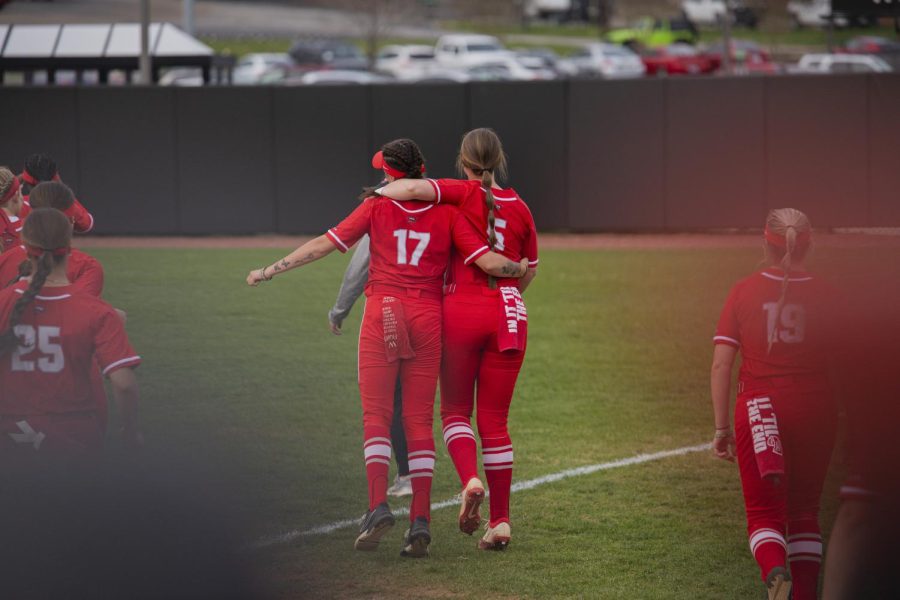 Hilltoppers+softball+Savannah+Fierke+%2817%29+and+Katie+Gardner+%285%29+hold+each+other+close+as+they+skip+to+the+outfield+before+their+matchup+with+Razorbacks+of+the+University+of+Arkansas+on+March+21st+at+the+WKU+Softball+Complex.