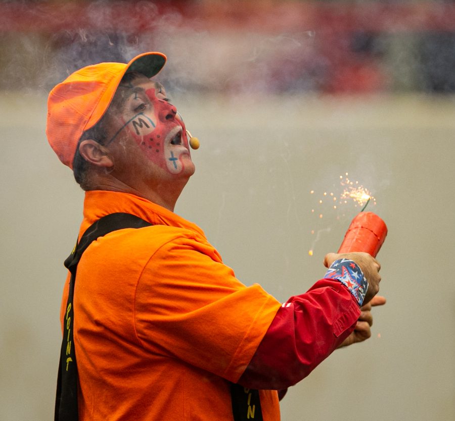 A rodeo clown holds a lit firecracker Friday evening, March 25, 2022 at Western Kentucky University’s L.D. Brown Ag Expo Center for the 40th Annual Lone Star Rodeo.