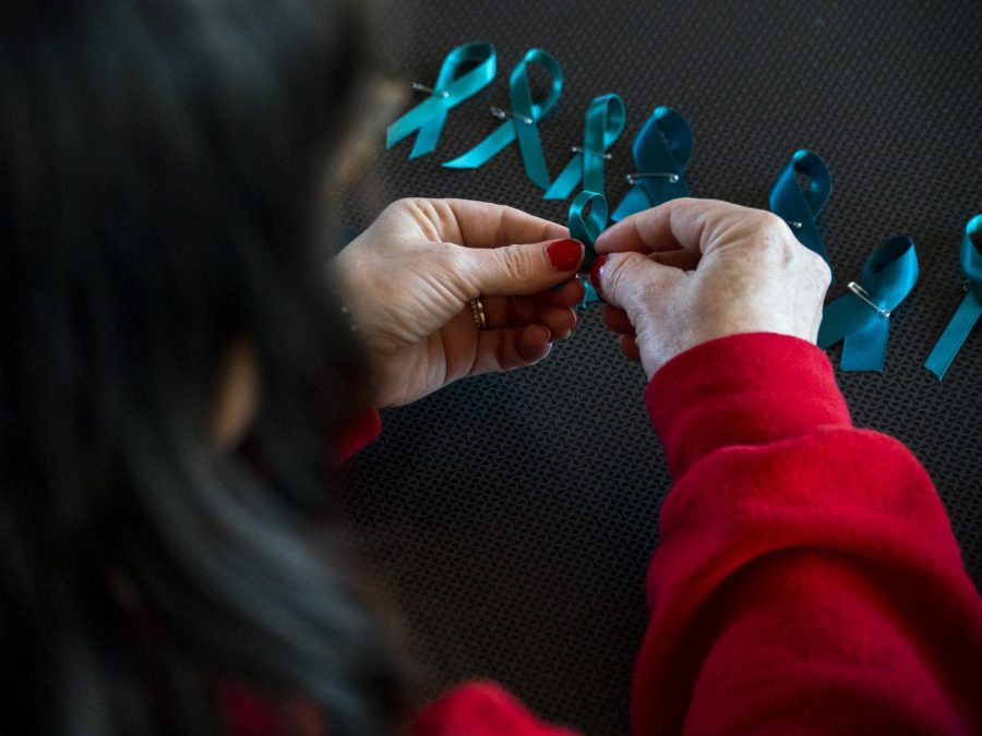 A student helps make teal ribbons in support of sexual assault awareness at Tina Smajlagic’s discussion on the #MeToo movement in Downing Student Union on Apr. 14, 2022.