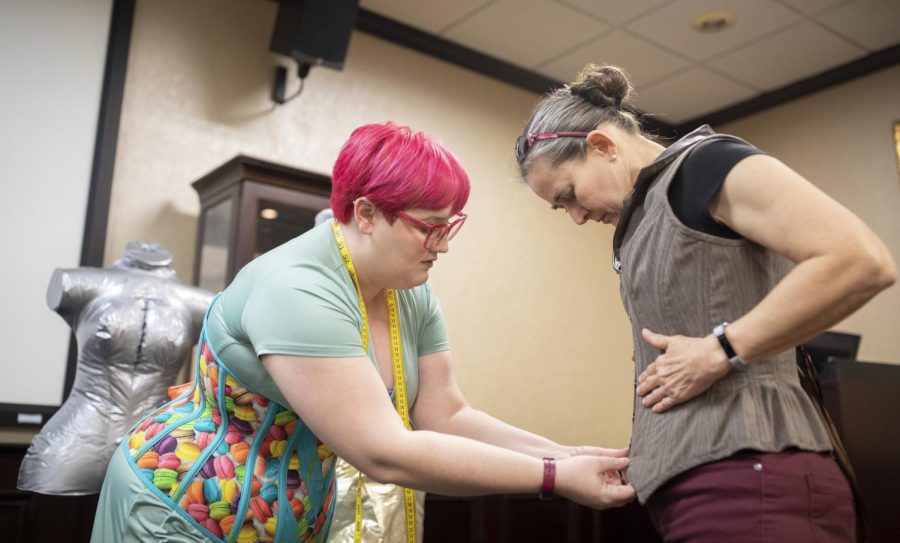 Alisha Martin assists an attendee at her exposition on modern corsetry into a corset in the Kentucky Museum on Thursday, April 14.