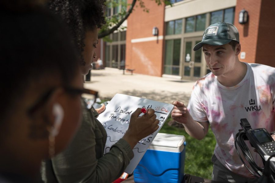 WKU graduate student Matt Wisenden uses a Pro DSS multi-parameter instrument to measure various attributes from water samples taken from campus buildings during the Earth Day Festival on Friday, April 22.