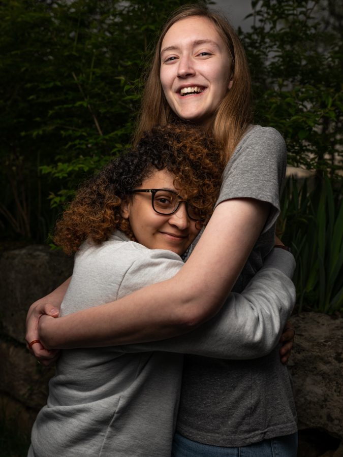 Western Kentucky University students Elizabeth Roth (right) and Michaela Snyder (left) pose for couple portraits near campus’s iconic “Kissing Bridge” behind Cherry Hall on Friday, April 15, 2022.