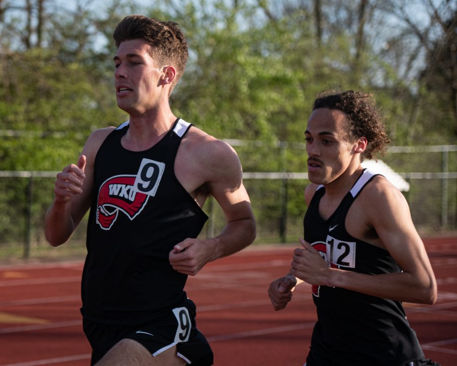 Seniors Clint Sherman (left) and Dedrick Troxell (right) compete in a distance race during day one the Western Kentucky University Hilltopper Relays Friday, April 1, 2022 at the Charles M. Ruter Track and Field Complex in Bowling Green, Kentucky.