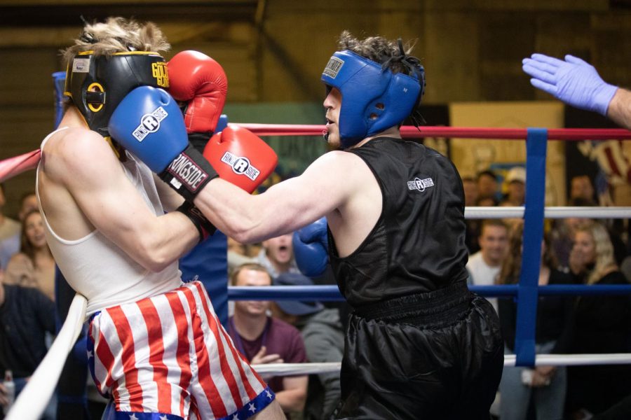 In the first boxing match of the night at Sigma Chi’s Fight Night, Jansyn Todd (blue) hits Jacob Lann (red). Todd came back to win the match overall.
