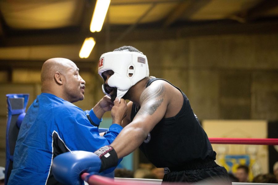 Dejuan Alexander talks to his coach on the side of ring in-between rounds during his boxing match at Sigma Chi’s Fight Night on Friday, April 8th. Alexander won his match against LaTravius Robinson.
