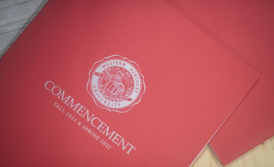 Commencement documents lay on the floor of the WKU auxiliary gym as graduates gather inside before heading to the floor of E.A. Diddle Arena for the graduation ceremony of the Ogden College of Science and Engineering on Friday, May 6. 