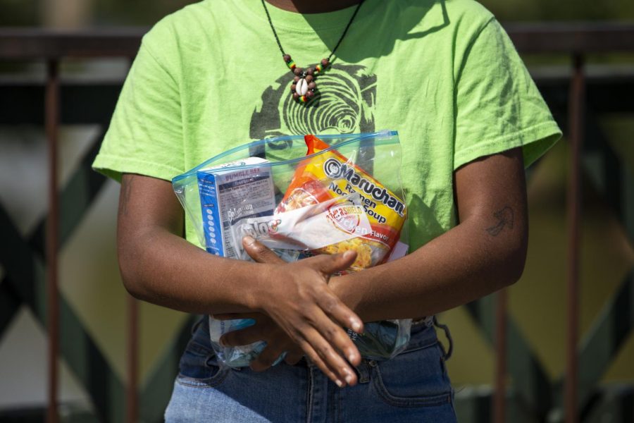 Daisy Carter holds a “goodie bag” with food and hygiene products to give to people in need during the Walk for the Homeless event put on by Rise and Shine, a mutual aid group, in Bowling Green, Ky. on Sept. 17, 2022.
