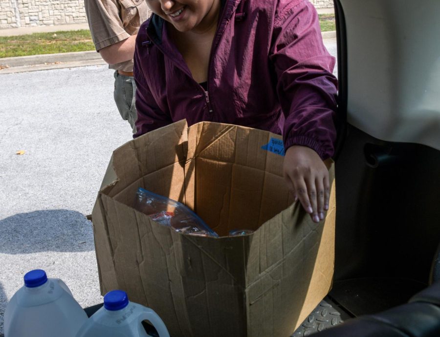 Jada Barnett takes the “goodie bags” made to give to homeless people out of her car after arriving at Lampkin Park as part of the Walk for the Homeless event put on by Rise and Shine, a mutual aid group, in Bowling Green, Ky. on Sept. 17, 2022.