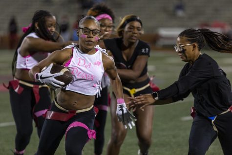 A player on the pink team runs to avoid getting her flags ripped off during Powderpuff at WKU on Feix Field in Bowling Green, Ky. on Sept. 28, 2022.
