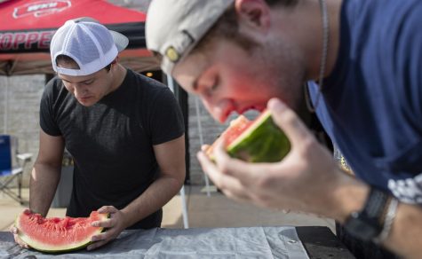 Nick Nopper and Zach Stout take part in a watermelon eating contest during watermelon bust at the Lambda Chi Alpha chapter house on WKU Campus in Bowling Green, Ky. on Friday, Sept. 9, 2022.
