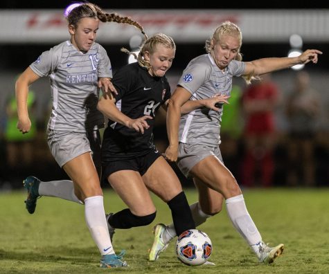Western Kentucky University Hilltoppers forward Kayla Meyer (24) jockeys for control of the ball over University of Kentucky Wildcats freshman midfielder Mallory Glass (15) and senior defender Maggy Henschler (9) during a match on Wednesday evening, Sept. 1 at the WKU Soccer Complex in Bowling Green, Ky. WKU won the match 1-0.