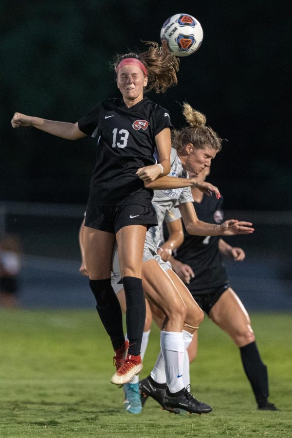 Western Kentucky University Hilltoppers senior forward Katie Erwin (13) goes up for a header against a member of the University of Kentucky Wildcats during a match on Wednesday evening, Sept. 1 at the WKU Soccer Complex in Bowling Green, Ky. WKU won the match 1-0.