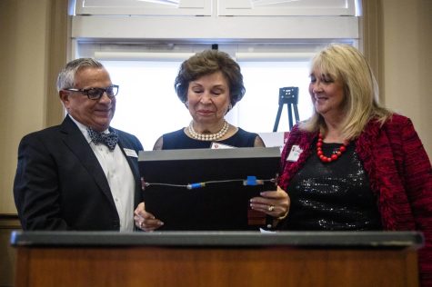 Dr. Joseph Cangemi’s wife Amelia, center, looks at the Dean’s Award she is accepting posthumously for him with two of his longtime colleagues, Ronda Talley, right, and Gerardo Gonzalez on Tuesday, Oct. 25, 2022. Talley was a student to Cangemi before becoming at psychology professor at WKU, and Gerardo is a professor and dean emeritus at Indiana University, where he met Cangemi. Both were part of a group that nominated Cangemi for this award.