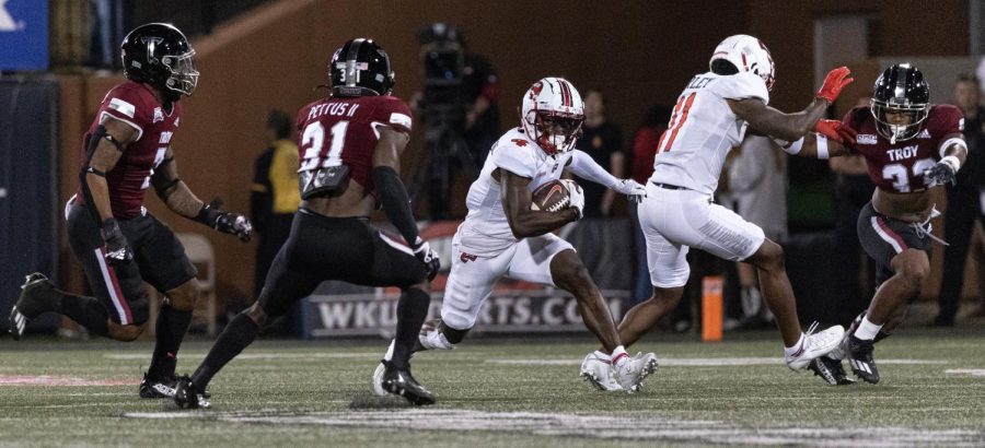 Western Kentucky University Hilltoppers junior wide receiver Michael Mathison (4) runs the ball against the Troy University Trojans Saturday evening, Oct. 1, 2022 on Jimmy Feix Field on the WKU campus in Bowling Green, Ky. Hilltoppers fell to the Trojans 34-27. 