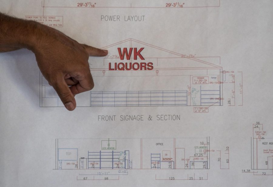 Manojkumar Patel, owner of WK Liquors, talks about some of the new features the rebuilt store will have when it reopens while showing the building plans on Oct. 3, 2022 in Bowling Green, Ky. Patel has done a lot of research into rebuilding after tornado damage, changing the roof shape to a pitched roof and where windows are so it can better withstand storm damage in the future.