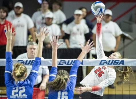 WKU sophomore outside hitter Katie Howard hits the ball through MTSU defense during the Conference USA Tournament in E.A. Diddle Arena on Friday, Nov. 18, 2022. WKU swept the match 3-0.