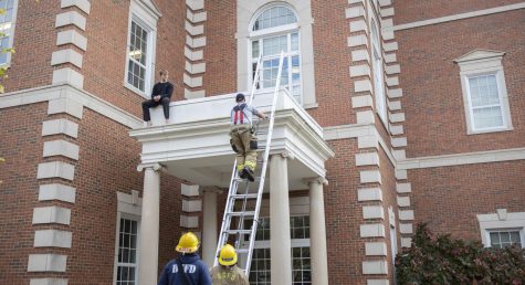Members of the Bowling Green Fire Department climb up to Ethan Denton after he climbed up the side of Gary Ransdell Hall on Monday, Nov. 7, 2022.