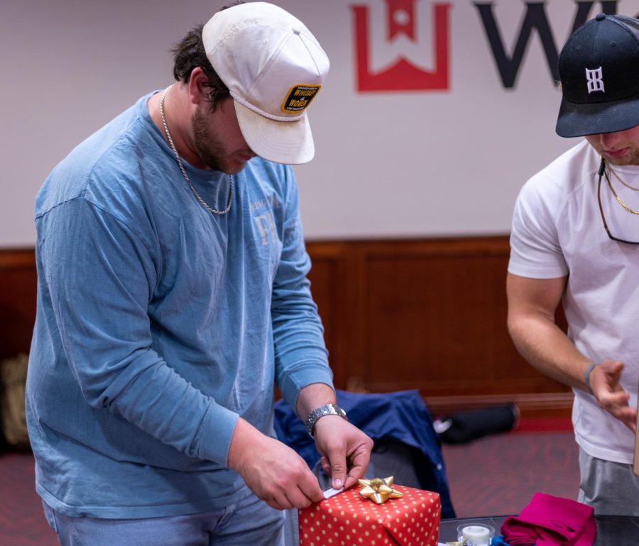 Members of WKU fraternities participate in the Greek Christmas Angel event inside Downing Student Union on Tuesday, Nov. 29, 2022.
