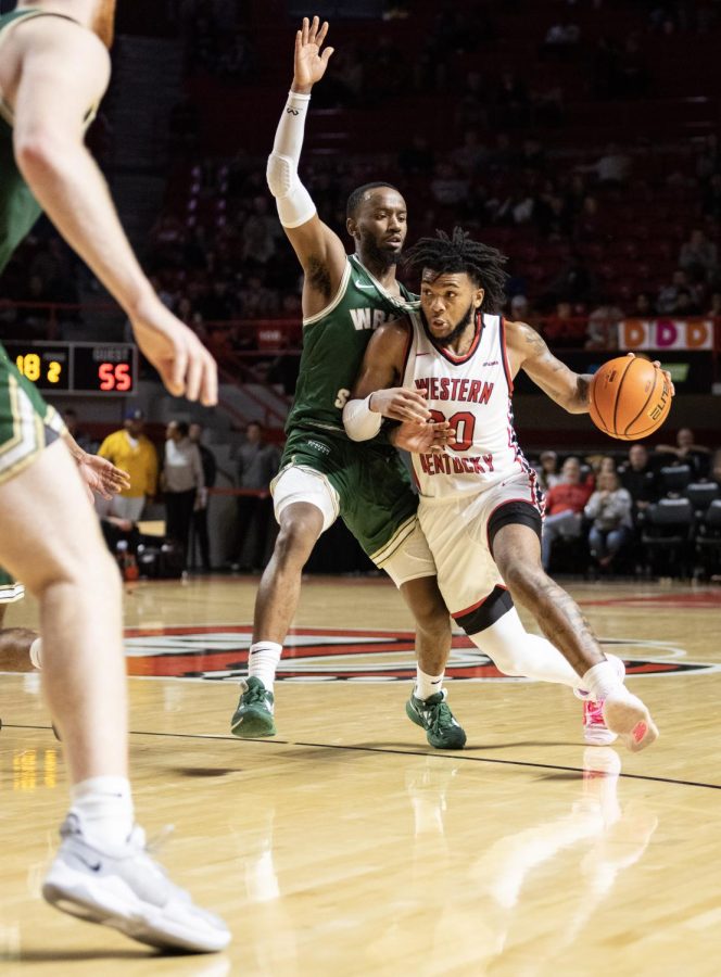 WKU+junior+guard+Dayvion+McKnight+drives+the+ball+into+his+zone+during+the+matchup+with+Wright+State+in+E.A.+Diddle+Arena+on+Saturday%2C+Dec.+10%2C+2022.+WKU+won+64-60.