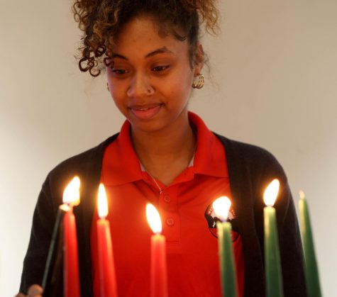 Tylia Standard lights the candle for Kuumba during the Kwanzaa celebration at Mahurin Honors College at WKU on Thursday, Dec. 1, 2022.