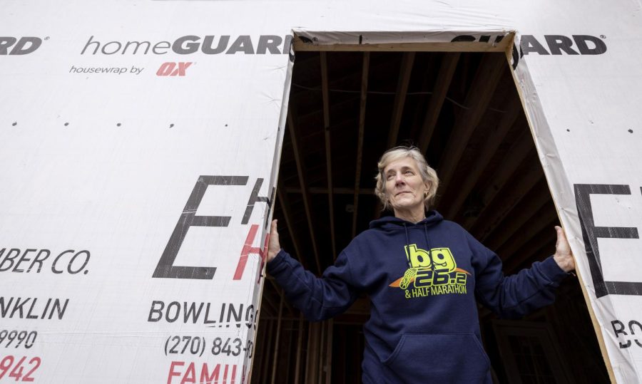 Lilly Riherd stands in the construction of her Bowling Green home that was hit by the tornado in 2021 on Saturday, Jan. 14, 2023.