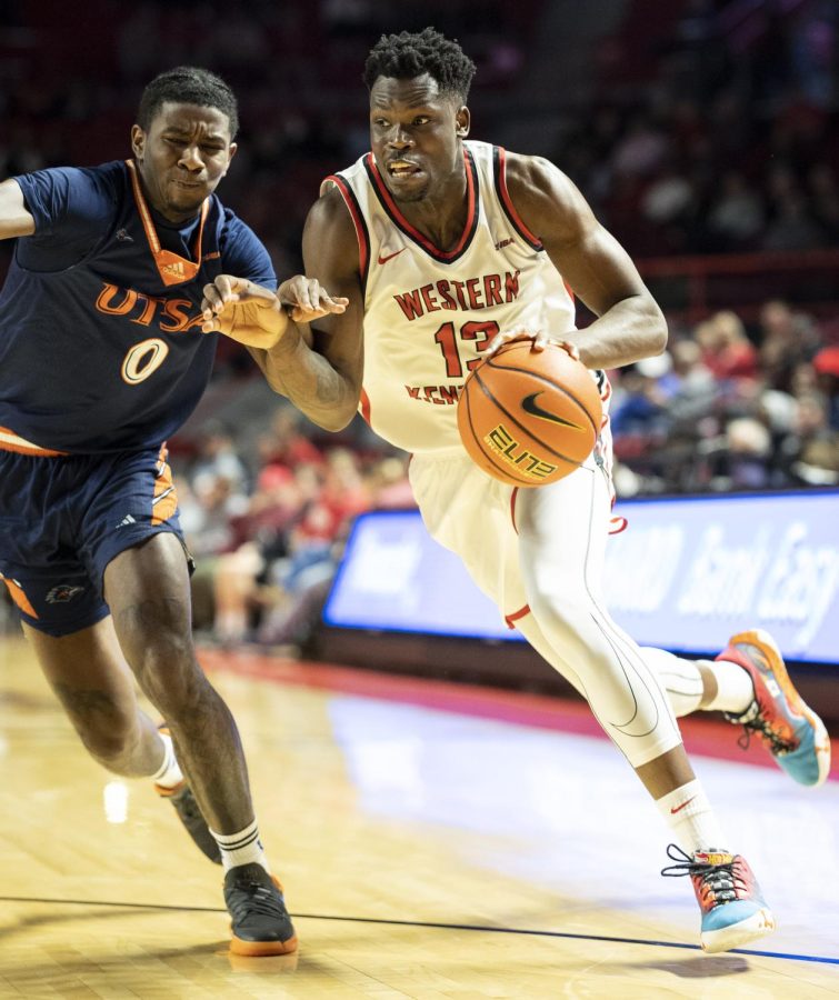 Sixth year guard Emmanuel Akot (13) drives the ball into the paint during the matchup with UTSA in E.A. Diddle Arena on Thursday, Feb. 2, 2023. WKU won 81-74.