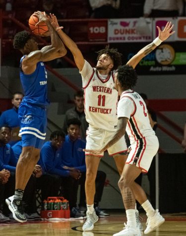 WKU Hilltoppers redshirt junior shooting guard Dontaie Allen (11) guards MTSU Blue Raiders junior guard Eli Lawrence (5) during the first half of the match against the MTSU Blue Raiders on Thursday, Feb. 9, 2023 at Diddle Arena in Bowling Green, Ky. WKU won the match 93-89.