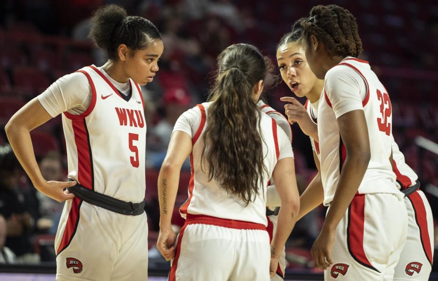 Sophomore forward Jaylin Foster (11) (right) talks strategy with her teammates during the matchup with UNT in E.A. Diddle Arena on Saturday, March 4, 2023. WKU won 76-67.