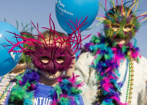 Participants in the Kiddie Krewe Parade march with masks on at the first Bowling Green Mardi Gras Madness event on Saturday, March 4, 2023 in Downtown Bowling Green, Ky. 