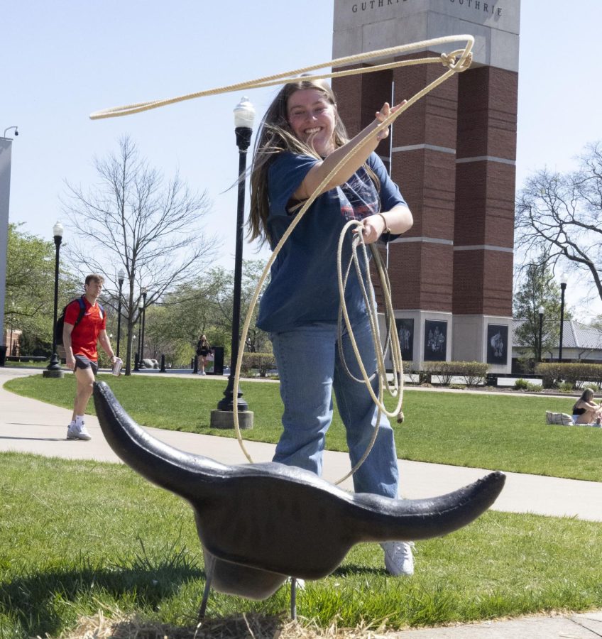 Chandler Miller, a senior communications major, practices her lasso skills during the Horses on The Hill therapy event on Tuesday April 11, 2023, on South Lawn.