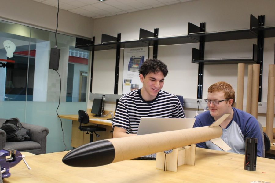 Omar Mansour, president of the Big Red Rocketry Association, and Alexander Bentley, a club member, view rocket simulations to prepare for an upcoming rocket launch.