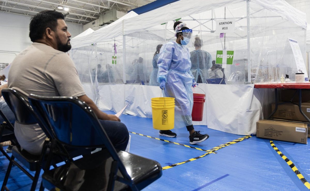 A nurse walks past dental tents during a Remote Area Medical (RAM) clinic at Teranga Academy in Bowling Green, Ky. on Aug. 26, 2023. 