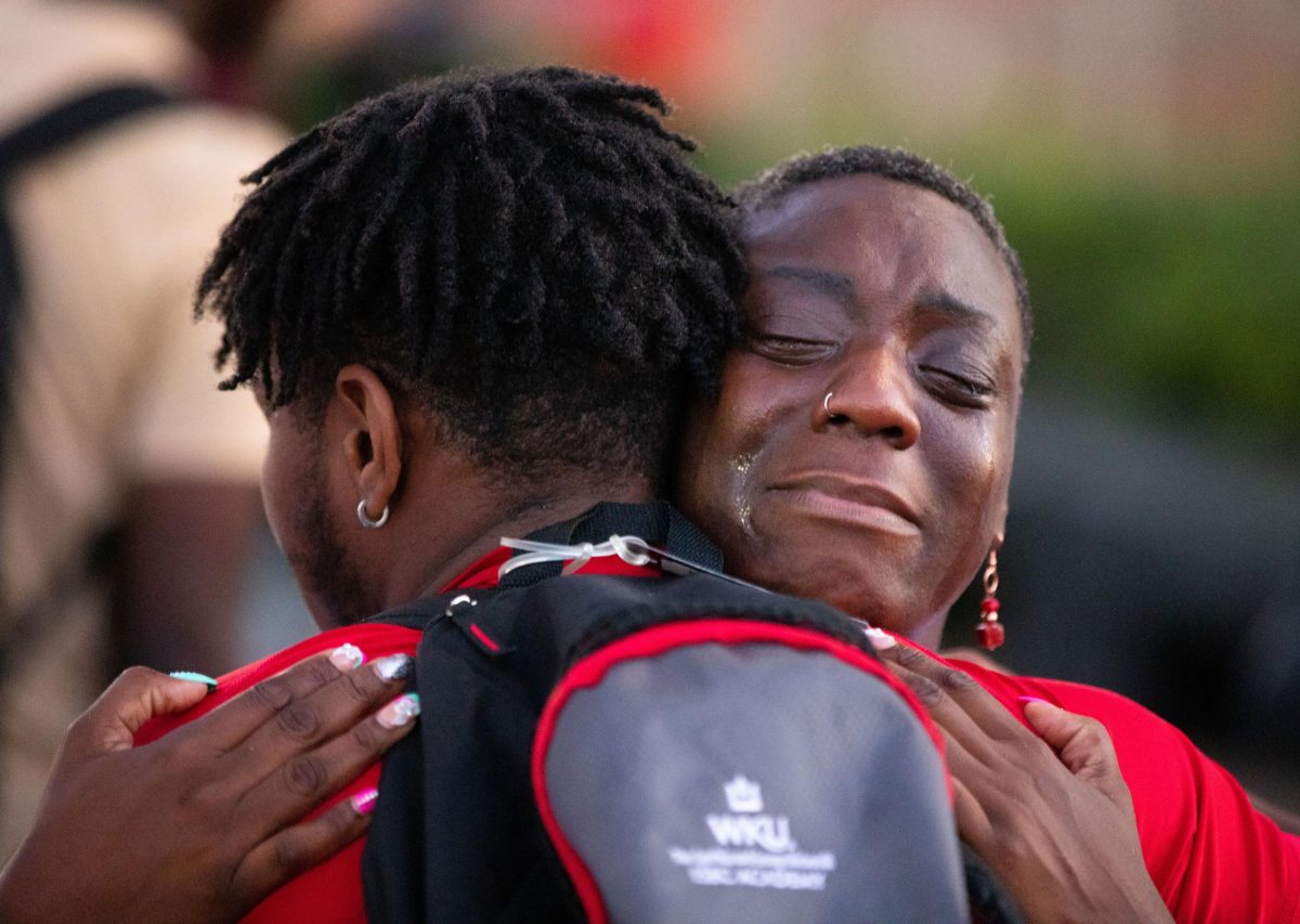 Misha Baskerville hugs a WKU student during a vigil for her daughter, Ayanna Morgan, at Guthrie Bell Tower in Bowling Green, Ky. on Tuesday, August 29, 2023. 