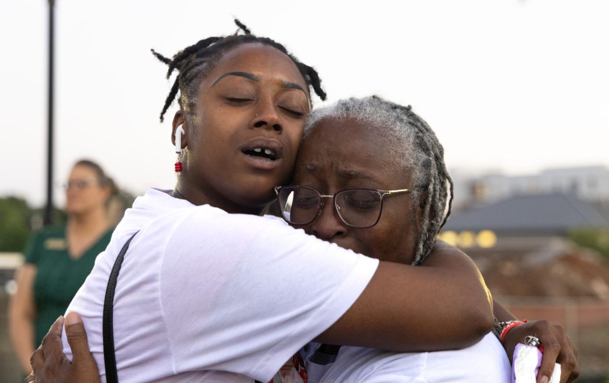 Aerial Stuckey, friend of Ayanna Morgan, embraces Morgan’s grandmother Veronica Hirams during a vigil for Morgan at Guthrie Bell Tower on Aug. 29, 2023. Stuckey met Morgan in Cherry Hall during their freshman year at WKU. “She gave me a compliment and I gave her a compliment,” Stuckey said. “It was an instant friendship.”