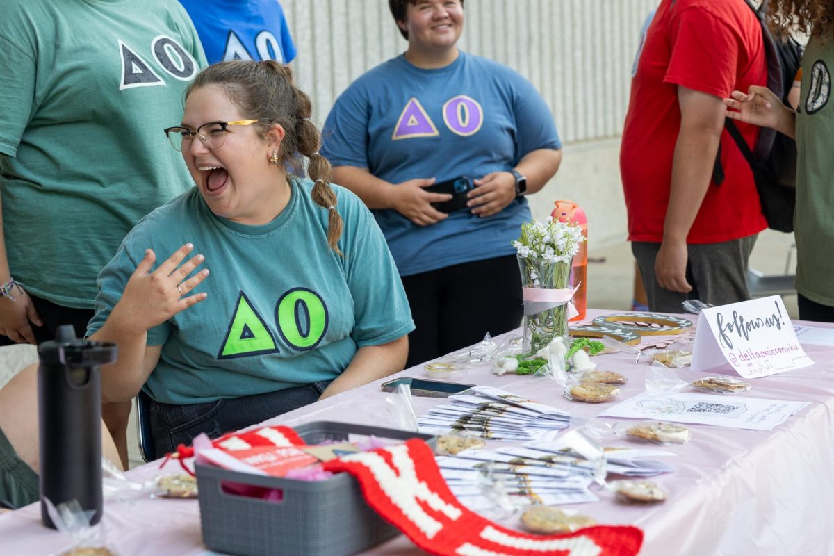 Alison Schimmell, Vice President of Delta Omicron at WKU, works at a table for the fraternity at the WKU Music Back to School Bash at Western Kentucky University in Bowling Green, KY on August 24, 2023. Delta Omicron is the only co-ed music sorority on campus out of three, and anyone majoring or minoring in music can join.