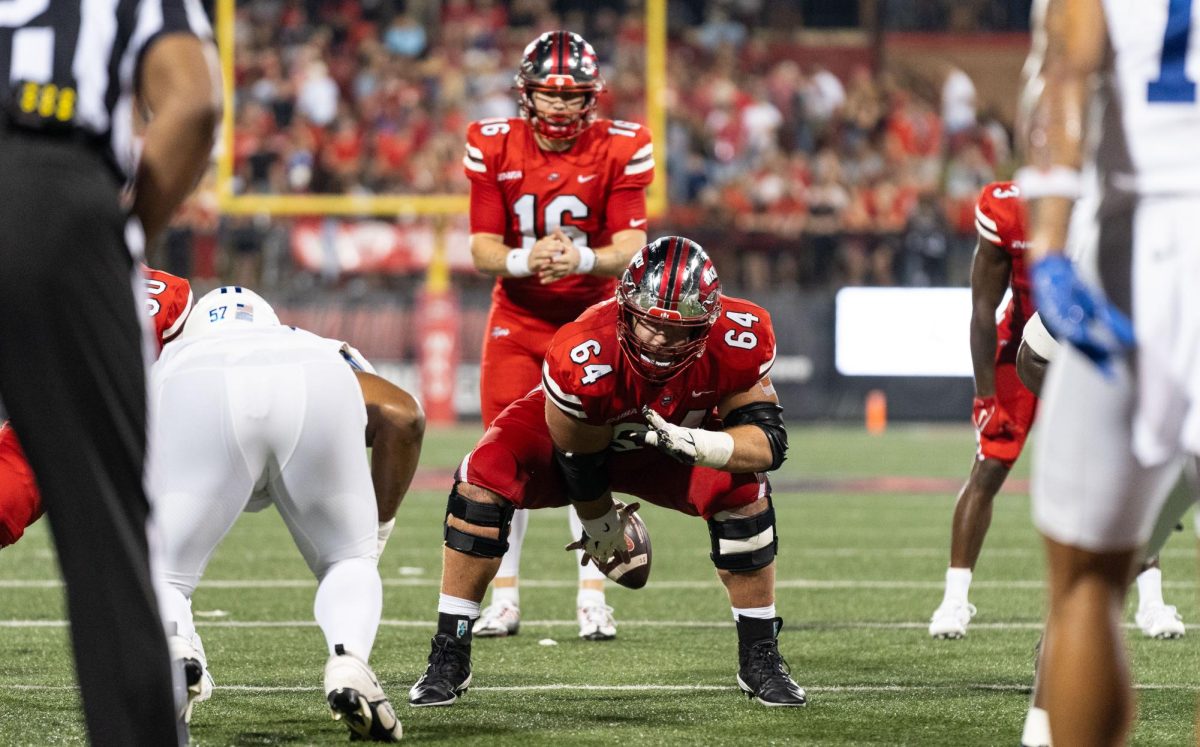 Offensive line Vincent Murphy (64) snaps a ball to quarterback Austin Reed (16) on Sept. 28, 2023, at L.T. Smith Stadium during the matchup with MTSU.