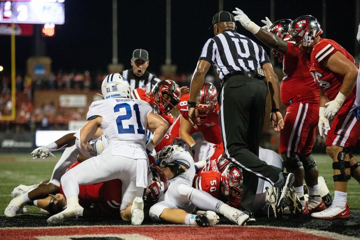 Under the dog pile, quarterback Austin Reed scores a touchdown during a game against Middle Tennessee State University at L.T Smith Stadium  in Bowling Green on Thursday, Sept. 28, 2023. 