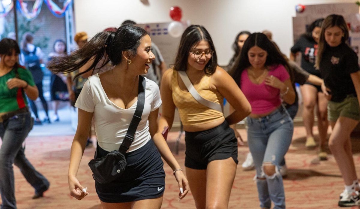 A student dances to a Latin American party dance at the All Around the World event in the Honors College and International Center on Sept. 14, 2023.