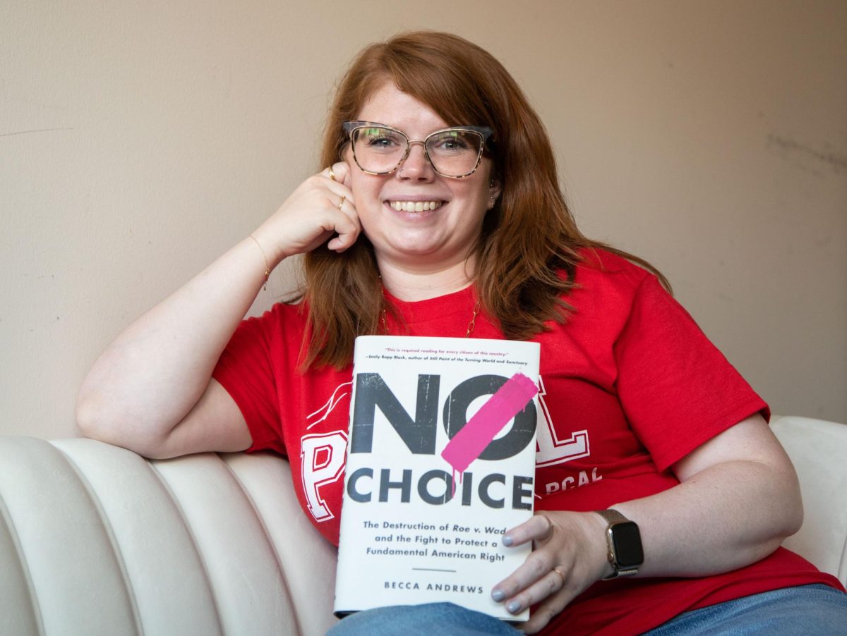 Assistant Professor Becca Andrews poses with her book “No Choice” in her office at Jody Richards Hall on WKU’s campus in Bowling Green on Friday Sept. 1, 2023. 