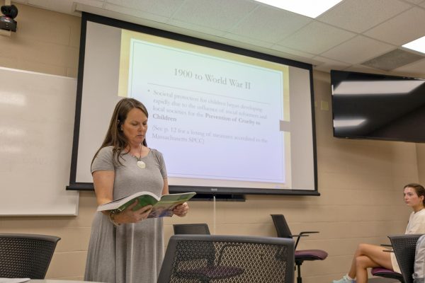 Professor Julie Jones references her textbook while teaching a lecture on the history of child welfare in the United States for their Introduction to Child Welfare class at Western Kentucky University.