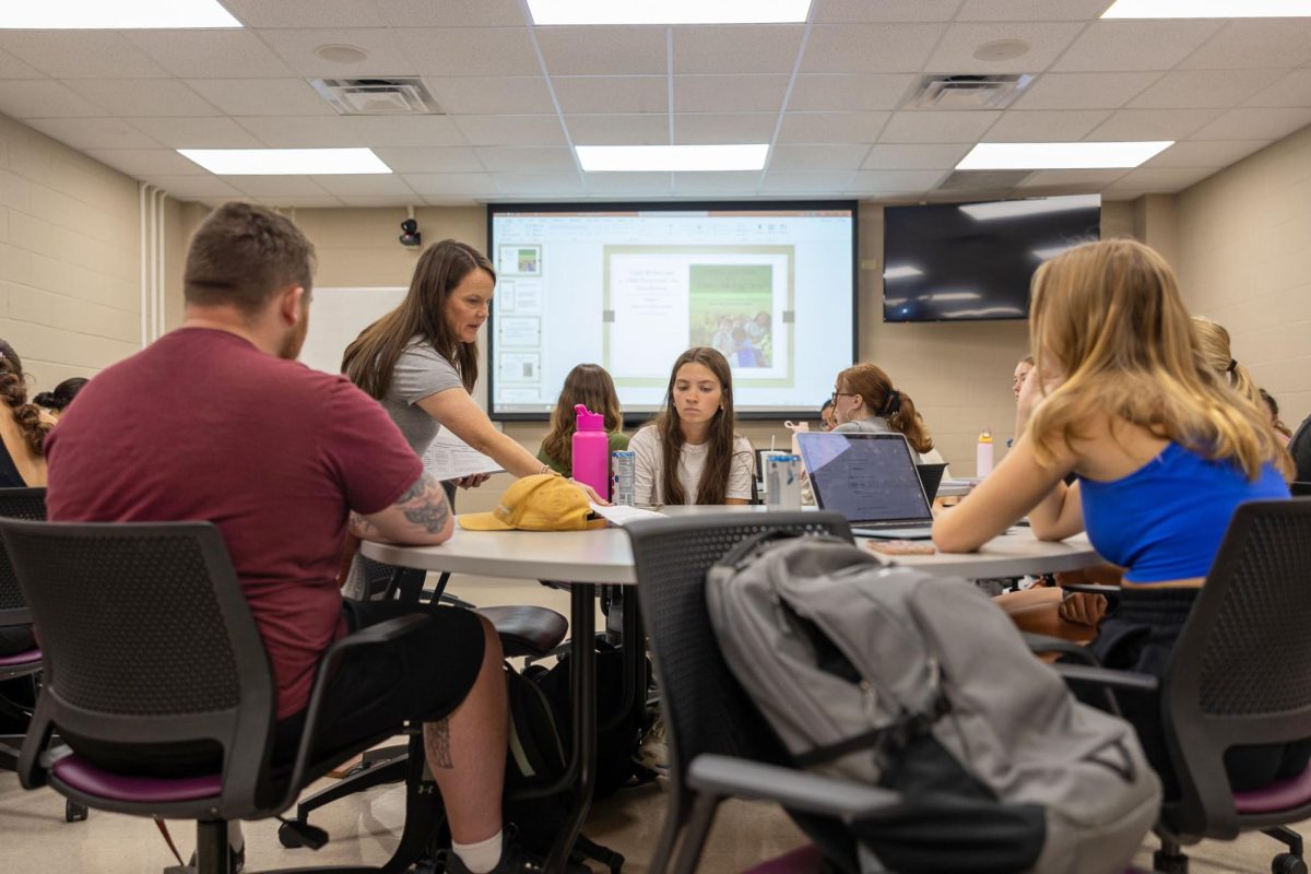 Students in Professor Julie Jones’s Introduction to Child Welfare class at Western Kentucky University receive a handout about Kentucky’s policies on “mandated reporting.”