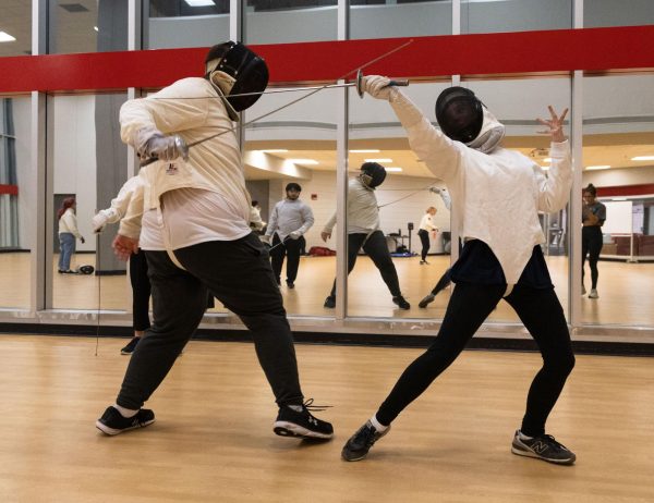 Junior Gigi Lamb, right, parries a strike from sophomore A.J. Ward while sparring during Fencing Club at the Raymond B. Preston Health & Activities Center on WKU’s Campus on Tuesday, Sept. 12, 2023.  Lamb and Ward are in their second semester fencing and plan to participate in Eastern Kentucky University’s Halloween Open. 
