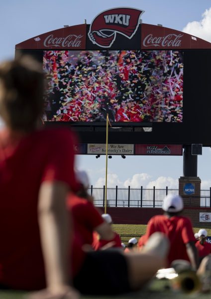 Members of the Big Red Marching Band watch an invitation video to the London New Years Day Parade at the Houchens Industries L.T. Smith Stadium on Monday, Sept. 18, 2023.