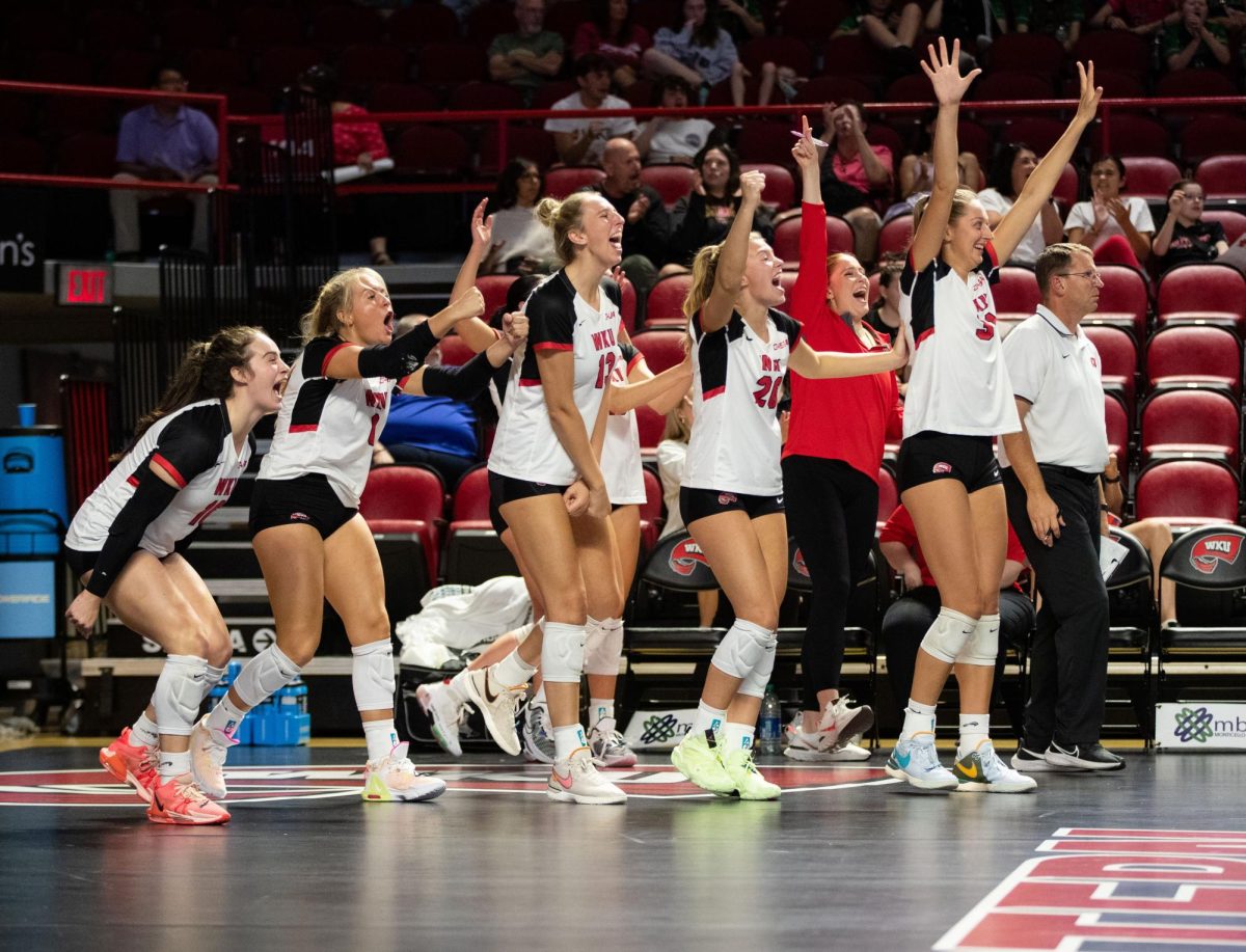 WKU Volleyball players cheer on their teammates after scoring a point during the WKU Volleyball match against University of Arkansas at the E.A Diddle Arena in Bowling Green on Wednesday, Sept. 8, 2023. 