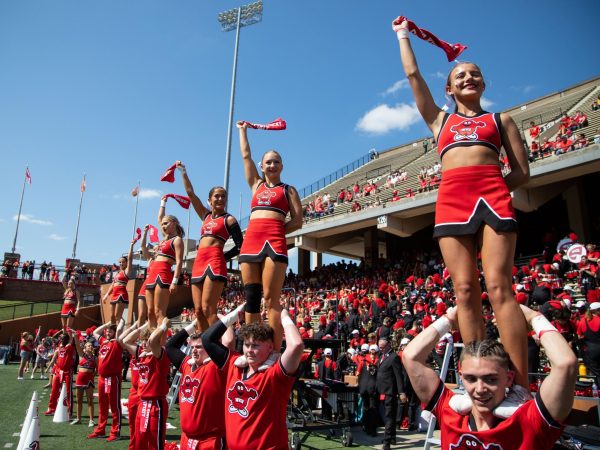 Cheerleaders wave red towels and cheer during a game against University of South Florida at Smith Stadium in Bowling Green, Ky. on Saturday, Sept. 2, 2023. 